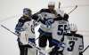 Winnipeg Jets players congratulate goaltender Connor Hellebuyck after a shutout performance against the Vancouver Canucks' in Vancouver, Monday. (TREVOR HAGAN / WINNIPEG FREE PRESS)