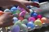 In this Wednesday, April 8, 2020, photo Jack Rothenberg, 6, of Glen Burnie, Md., selects an egg, to participate in an egg tapping battle with his family. The Rothenberg's have a tradition of coloring eggs, having an egg tapping battle, and an Easter egg hunt. (AP Photo/Susan Walsh)