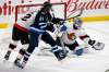Ottawa Senators goaltender Anton Forsberg makes a glove save as Winnipeg Jets' Kyle Connor looks for the rebound during the first period in Winnipeg on Monday. THE CANADIAN PRESS/Fred Greenslade