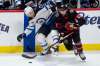 Ottawa Senators centre Michael Amadio takes the puck away from Winnipeg Jets centre Trevor Lewis during the first period Monday in Ottawa. THE CANADIAN PRESS/Adrian Wyld