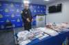 Winnipeg police Const. Rob Carver shows off the cash, jewelry and drugs seized during Project Matriarch. (Mike Deal / Winnipeg Free Press)