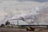 A dump truck works near the Syncrude oil sands extraction facility near the city of Fort McMurray, Alta., on June 1, 2014. The parliamentary budget office says most Canadian households will receive more money back from the federal government's carbon-tax scheme than it will cost them. The assertion is contained in a report published by the PBO this morning, nearly four months after a majority of Canadian voters cast their ballots in favour of parties that favoured a carbon tax. THE CANADIAN PRESS/Jason Franson