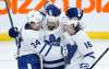 Toronto Maple Leafs' Auston Matthews (34), Nick Foligno (71) and Mitchell Marner (16) celebrate a win over the Winnipeg Jets in NHL action in Winnipeg on Thursday. THE CANADIAN PRESS/John Woods
