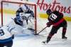 Winnipeg Jets goaltender Laurent Brossoit makes a pad save on Ottawa Senators left wing Tim Stützle during the third period in Ottawa, Monday. THE CANADIAN PRESS/Adrian Wyld