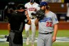 Los Angeles Dodgers starting pitcher Clayton Kershaw talks with home plate umpire Cory Blaser during the first inning in Game 4 of a baseball National League Championship Series against the Atlanta Braves Thursday, Oct. 15, 2020, in Arlington, Texas. (AP Photo/Eric Gay)