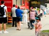 A young boy plays on a phone as he waits in line at a COVID assessment centre at Mount Sinai Hospital during the COVID-19 pandemic in Toronto on Thursday, September 24, 2020. THE CANADIAN PRESS/Nathan Denette