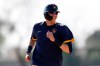 FILE - In this Feb. 19, 2020, file photo, Milwaukee Brewers' Christian Yelich reacts during a spring training baseball workout in Phoenix. The Brewers are reportedly working on a new contract with star slugger Christian Yelich. It's an encouraging sign for Milwaukee after it lost a couple key performers during free agency. (AP Photo/Gregory Bull, File)