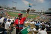 FILE - In this April 9, 2007, file photo, peanut vendor Richard Aller tosses a bag to a buyer during the Los Angeles Dodgers home opener baseball game against the Colorado Rockies in Los Angeles. Most teams and leagues are reticent to discuss the financial impact from the coronavirus pandemic. There's a loss that's going to take place industry-wise. It's simply unavoidable,‚Äù said Marc Ganis, the co-founder of Chicago-based consulting firm SportsCorp. ‚ÄúIf they can come back, they can reduce the loss for the players, the coaches, the people who work the ticket booths. The ushers, the security people, the parking lot attendants and concessionaires. All of these people ‚Äî thousands for a football game or baseball game. These are the people that need money, who need to work.‚Äù (AP Photo/Branimir Kvartuc, File)