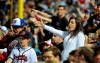 FILE - In this May 2, 2014, file photo, Atlanta Braves fans do the tomahawk chop during the ninth inning of a baseball game with the San Francisco Giants, in Atlanta. The Atlanta Braves say they have no plans to follow the lead of the NFL's Washington Redskins and change their team name. The team said in a letter to season ticket holders they are examining the fan experience, including the tomahawk chop chant, and have formed a 