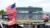 FILE - In this July 4, 2015, file photo, confederate and American flags fly on top of motor homes at Daytona International Speedway in Daytona Beach, Fla. Bubba Wallace, the only African-American driver in the top tier of NASCAR, calls for a ban on the Confederate flag in the sport that is deeply rooted in the South. (AP Photo/Phelan M. Ebenhack, File)