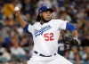 FILE - In this Tuesday, Oct. 16, 2018 file photo, Los Angeles Dodgers relief pitcher Pedro Baez throws during the sixth inning of Game 4 of the National League Championship Series baseball game against the Milwaukee Brewers in Los Angeles. Dodgers reliever Pedro Báez asked an arbitration panel for a raise to $4 million and Los Angeles argued during a hearing on Tuesday, Feb. 11, 2020 that he should be paid $3.5 million. (AP Photo/Jae Hong, File)
