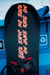 In a photo provided by Burton, a snowboard with stickers reading “Ride On Jake” sits on display before hundreds of riders honored the late Jake Burton Carpenter by taking a trip down his favorite run in Vail, Colo., Friday Feb. 28, 2020. Carpenter died in November 2019 from a relapse of testicular cancer. (Dean Blotto Gray/Burton via AP)