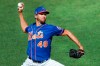 FILE - In this July 9, 2020, file photo, New York Mets starting pitcher Jacob deGrom winds up while delivering during a simulated baseball game, part of the Mets summer training camp workout, at Citi Field in New York. Pete Alonso at the plate. Jacob deGrom on the mound. And a healthy Yoenis Céspedes pegged conveniently for designated hitter. There’s no question the New York Mets have reasons to believe this pandemic-shortened season is perfect for them -- even without injured starter Noah Syndergaard. All they need to do is pick right up where they left off last year.(AP Photo/Kathy Willens, File)