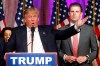 FILE - In this Tuesday, March 15, 2016 file photo, Republican presidential candidate Donald Trump speaks to supporters at his primary election night event at his Mar-a-Lago Club in Palm Beach, Fla. At right is his son Eric Trump. New York City is looking to terminate its contracts with Trump to run two Central Park skating rinks and other facilities after a Trump-inspired mob rioted and breached the U.S. Capitol, Mayor Bill de Blasio said Tuesday, Jan. 12, 2021. (AP Photo/Gerald Herbert)