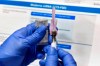 FILE - In this Monday, July 27, 2020 file photo, a nurse prepares a syringe during a study of a possible COVID-19 vaccine, developed by the National Institutes of Health and Moderna Inc., in Binghamton, N.Y. With coronavirus vaccines on the horizon, when and where will most Americans get their shots? Many of the details are still being worked out, as regulators review the first vaccine candidates. A federal panel of vaccine experts is meeting this week to consider Pfizer's vaccine, and again next week for Moderna's. (AP Photo/Hans Pennink)