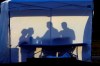 FILE - In this Wednesday, March 25, 2020 file photo, medical personnel are silhouetted against the back of a tent before the start of coronavirus testing in the parking lot outside of Raymond James Stadium in Tampa, Fla. As cases skyrocket in the U.S. and Europe, it’s becoming more clear that how healthy you were before the pandemic began plays a key role in how you fare regardless of how old you are. (AP Photo/Chris O'Meara)