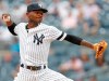 FILE - In this July 18, 2019, file photo, New York Yankees' starting pitcher Domingo German winds up during the first inning in the first game of a baseball doubleheader in New York. Suspended Yankees pitcher German cast doubt on his baseball future with a curious Instagram post Friday, July 17, 2020, night. (AP Photo/Kathy Willens, File)