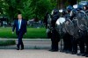 FILE - In this Monday, June 1, 2020, file photo, President Donald Trump walks past police in Lafayette Park after visiting outside St. John's Church across from the White House in Washington. Part of the church was set on fire during protests on Sunday night. (AP Photo/Patrick Semansky, File)