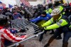 FILE - In this Jan. 6, 2021, file phtoo, Trump supporters try to break through a police barrier at the Capitol in Washington. In its annual report set to be released Monday, Feb. 1, 2021, the Southern Poverty Law Center said it identified 838 active hate groups operating across the U.S. in 2020. The SPLC’s report comes out nearly a month after a mostly white mob of Trump supporters and members of far-right groups violently breached the U.S. Capitol building. (AP Photo/John Minchillo, File)