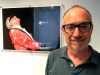 FILE - In this June 18, 2018, file photo, Gregory Katz, acting London bureau chief for The Associated Press, poses for a photo backdropped by a photo of American pianist singer songwriter Ray Charles, at the AP's London office. Katz, an acclaimed correspondent for The AP whose career over four decades took him across the globe, died Monday, June 22, 2020. He had been ill in recent months and had contracted COVID-19. He was 67. (AP Photo/File)