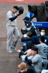 New York Yankees' Gary Sanchez, top, walks back to the dugout after grounding out to Toronto Blue Jays third baseman Joe Panik during the second inning of a baseball game in Buffalo, N.Y., Tuesday, Sept. 8, 2020. (AP Photo/Adrian Kraus)