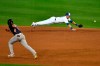 Toronto Blue Jays second baseman Joe Panik, right, can't reach a ball hit for a single hit by Boston Red Sox's Alex Verdugo as Boston's José Peraza, left, heads to second base during the sixth inning of a baseball game in Buffalo, N.Y., Tuesday, Aug. 25, 2020. (AP Photo/Adrian Kraus)