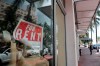 FILE - In this July 13, 2020 file photo, a For Rent sign hangs on a closed shop during the coronavirus pandemic in Miami Beach, Fla. Having endured what was surely a record-shattering slump last quarter, the U.S. economy faces a dim outlook as a resurgent coronavirus intensifies doubts about the likelihood of any sustained recovery the rest of the year. (AP Photo/Lynne Sladky)