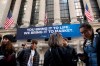 FILE - In this Monday, March 9, 2020 file photo, people stop to look at the New York Stock Exchange. Stocks are opening sharply lower on Wall Street Wednesday as fears of economic fallout from the coronavirus outbreak grip markets again. (AP Photo/Mark Lennihan, File)