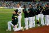 FILE - In this Sept. 23, 2017, file photo, Oakland Athletics catcher Bruce Maxwell kneels during the national anthem before the team's baseball game against the Texas Rangers in Oakland, Calif. Maxwell is the only major leaguer to take a knee during the playing of 