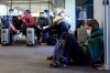 FILE- In this Oct. 15, 2020, file photo, passenger Cari Driggs, right, from Provo, Utah, waits to board a United Airlines flight to Hawaii for vacation at San Francisco International Airport in San Francisco. The CDC is strongly recommending that passengers on planes, trains and buses wear masks, but it's still stopping short of requiring face coverings to prevent spreading COVID-19. All leading U.S. airlines require passengers other than small children to wear masks during flights, but enforcement can be spotty. The Federal Aviation Administration has declined to require masks. (AP Photo/Jeff Chiu, File)