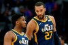 FILE - In this Saturday, March 7, 2020, file photo, Utah Jazz center Rudy Gobert (27) talks with guard Donovan Mitchell, left, during the second half of an NBA basketball game against the Detroit Pistons, in Detroit. Both players have tested positive for the coronavirus. Gobert's test result forced the NBA to suspend the season. (AP Photo/Duane Burleson, File)