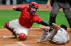 FILE - In this Aug. 24, 2020, file photo, Minnesota Twins' Luis Arraez, right, is tagged out by Cleveland Indians' Roberto Perez in the fifth inning in a baseball game in Cleveland. The Indians will exercise the $5.5 million contract in 2021 for catcher Roberto Perez, who has been exemplary in handling one of the AL's best pitching staffs. (AP Photo/Tony Dejak, File)