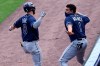 Tampa Bay Rays' Brandon Lowe, left, celebrates his go-ahead home run with Willy Adames, right, during the ninth inning in the continuation of a suspended baseball game against the Toronto Blue Jays, Sunday, Aug. 16, 2020, in Buffalo, N.Y. The first part of the game was suspended on Aug. 15 because of heavy rain. (AP Photo/Jeffrey T. Barnes)