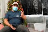 Gustavo Ajche, 38, who has three jobs, gestures after watching Joe Biden's presidential inauguration on TV with other immigrants at the offices of the Workers Justice Center, Wednesday, Jan. 20, 2021, in the Sunset Park neighborhood in New York. Atche has been in the United States since 2004. His wife is in the United States but his children are back in Guatemala while he and his wife pay for their college education there. Atche works construction, delivers food for food delivery applications, and works helping his community at a food pantry in Brooklyn. (AP Photo/Kathy Willens)