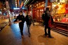 Tourists Gabby Vela and her husband, of San Antonio, bring a pizza back to their hotel Thursday, March 12, 2020, in New York's Times Square area near Broadway. The couple said they purchased the masks at Home Depot. The two were on spring break in the city, where New York Gov. Andrew Cuomo has banned gatherings of more than 500 people amid concerns over the coronavirus. (AP Photo/Kathy Willens)