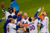 New York Mets' Pete Alonso, center, and teammates celebrate after Alonso hit a two-run home run during the 10th inning of the team's baseball game against the New York Yankees, Thursday, Sept. 3, 2020, in New York. (AP Photo/Kathy Willens)
