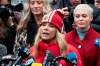 Actor Rosanna Arquette speaks as actor Rose McGowan, right, listens at a news conference outside a Manhattan courthouse after the arrival of Harvey Weinstein, Monday, Jan. 6, 2020, in New York. Weinstein is on trial on charges of rape and sexual assault, more than two years after a torrent of women began accusing him of misconduct. (AP Photo/Mark Lennihan)