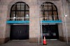 Retail space that used to house a New York Sports Club is available for lease on Wall Street, Thursday, July 30, 2020, in New York. Stocks are falling on Wall Street Thursday after reports showed that layoffs are continuing at a stubborn pace and that the U.S. economy contracted at a nearly 33% annual rate in the spring. (AP Photo/Mark Lennihan)