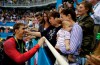 FILE - In this Tuesday, Aug. 9, 2016, file photo, United States' Michael Phelps celebrates winning his gold medal in the men's 200-meter butterfly with his mother Debbie, fiance Nicole Johnson and baby Boomer during the swimming competitions at the 2016 Summer Olympics in Rio de Janeiro, Brazil. Private, touching moment between loved ones won't be happening at the pandemic-delayed Tokyo Olympics. No spectators ‚Äî local or foreign ‚Äî will be allowed at the majority of venues, where athletes will hang medals around their own necks to protect against spreading the coronavirus. No handshakes or hugs on the podium, either. (AP Photo/Matt Slocum, File)