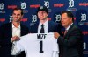 FILE - In this June 25, 2018, file photo, Detroit Tigers first overall pick Casey Mize, center, stands with Tigers scout Justin Henry, left, and Scott Pleis, director of amateur scouting, during a news conference where he was introduced to the media, in Detroit. Mize was the No. 1 pick in the 2018 draft. He's one of two pitchers headlining Detroit's rebuilding process. The Tigers held their first workout for pitchers and catchers Wednesday, Feb. 12, 2020 and while only the most optimistic Detroit fan would predict a great season in 2020, there are finally some signs of promise. (AP Photo/Carlos Osorio, File)