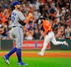 FILE - In this Aug. 4, 2017 file photo Toronto Blue Jays relief pitcher Mike Bolsinger, left, walks off the mound as Houston Astros' Marwin Gonzalez rounds the bases after hitting a three-run home run during the fourth inning of a baseball game in Houston. Bolsinger sued the Astros on Monday, Feb. 10, 2020 claiming their sign-stealing scheme contributed to a poor relief appearance August 2017 that essentially ended his big league career. (AP Photo/Eric Christian Smith, file)