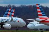 FILE - In this March 31, 2020 file photo American Airlines planes are parked at Pittsburgh International Airport in Imperial, Pa. Shares of American Airlines posted a record percentage gain Thursday, June 4, 2020 after the carrier said it will aggressively add back flights in July — a bet that the slow recovery in air travel will gain speed this summer as states re-open their economies. (AP Photo/Gene J. Puskar, file)