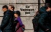 FILE - In this Thursday, Feb. 21, 2019, file photo, people walk by the One Franklin Square Building, home of The Washington Post newspaper, in downtown Washington. Washington Post political reporter Felicia Sonmez, who had been placed on administrative leave after she tweeted a link to a story about a 2003 rape allegation against Kobe Bryant, has been cleared to return to work, the paper said Tuesday, Jan. 28, 2020. (AP Photo/Pablo Martinez Monsivais, File)