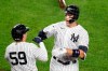 New York Yankees Aaron Judge, right, celebrates with the Yankees Luke Voit (59) after hitting a solo home run during the fifth inning of a baseball game against the Atlanta Braves, Tuesday, Aug. 11, 2020, in New York. (AP Photo/Kathy Willens)