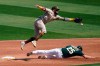 Oakland Athletics' Stephen Piscotty, bottom, steals second base under San Diego Padres shortstop Fernando Tatis Jr. during the second inning of a baseball game in Oakland, Calif., Saturday, Sept. 5, 2020. (AP Photo/Jeff Chiu)