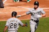 Chicago White Sox's Adam Engel, right, is congratulated by Leury Garcia after hitting a solo home run against the Oakland Athletics during the second inning of Game 1 of an American League wild-card baseball series Tuesday, Sept. 29, 2020, in Oakland, Calif. (AP Photo/Eric Risberg)