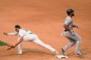Chicago White Sox's Jose Abreu, right, reaches first as Oakland Athletics first baseman Matt Olson drops the ball on a throwing error by shortstop Marcus Semien during the seventh inning of Game 3 of an American League wild-card baseball series Thursday, Oct. 1, 2020, in Oakland, Calif. (AP Photo/Eric Risberg)