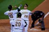 Oakland Athletics' Matt Olson (28) is greeted by Marcus Semien (10) and Mark Canha (20) after hitting a three-run home run off San Francisco Giants starting pitcher Logan Webb during the third inning of a baseball game Friday, Sept. 18, 2020, in Oakland, Calif. (AP Photo/Eric Risberg)