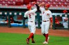 Cincinnati Reds' Nicholas Castellanos celebrates with Joey Votto (19) after hitting a grand slam in the fifth inning of the team's baseball game against the Chicago Cubs in Cincinnati, Wednesday, July 29, 2020. (AP Photo/Aaron Doster)