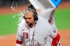Cincinnati Reds' Joey Votto is doused with ice water by teammate Jesse Winker after hitting an RBI walk-off single in a baseball game against the St. Louis Cardinals in Cincinnati, Wednesday, Sep. 2, 2020. The Reds won 4-3. (AP Photo/Aaron Doster)